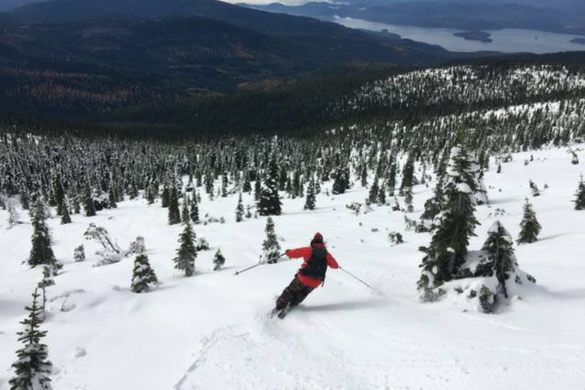 Jason Hershey makes turns in mid-October fresh snow from Mount Roothaan toward Priest Lake in the distance.
 (Chris Linden)