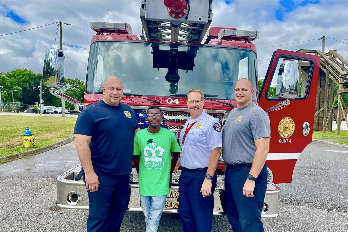 From left, Kevin Faddis, O’Tavais “OT” Harris, Justin Bailey and Mark Wilbanks. Faddis and Wilbanks, of the Knoxville Fire Department in Tennessee, helped deliver Harris 18 years ago when his mother couldn’t reach the hospital in time. All three men have been teaching Harris the basics of their jobs through a Knoxville summer internship program.  (Knoxville Fire Department)