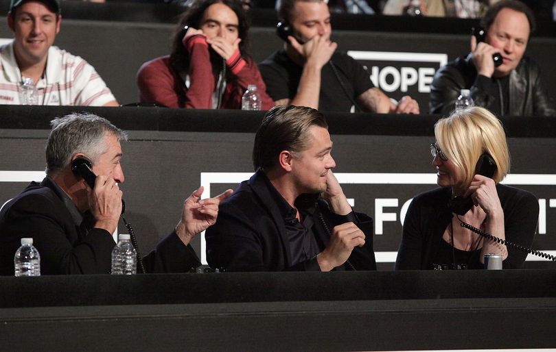 In this image released by Hope for Haiti Now, Robert De Niro, left, Leonardo DiCaprio and Ellen Barkin, right, work the phone bank at 