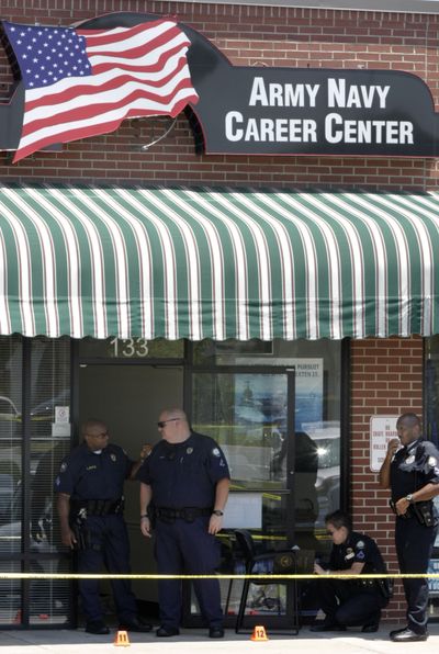 Police inspect the scene of a fatal shooting outside a military recruitment office in Little Rock, Ark., on Monday.  (Associated Press / The Spokesman-Review)