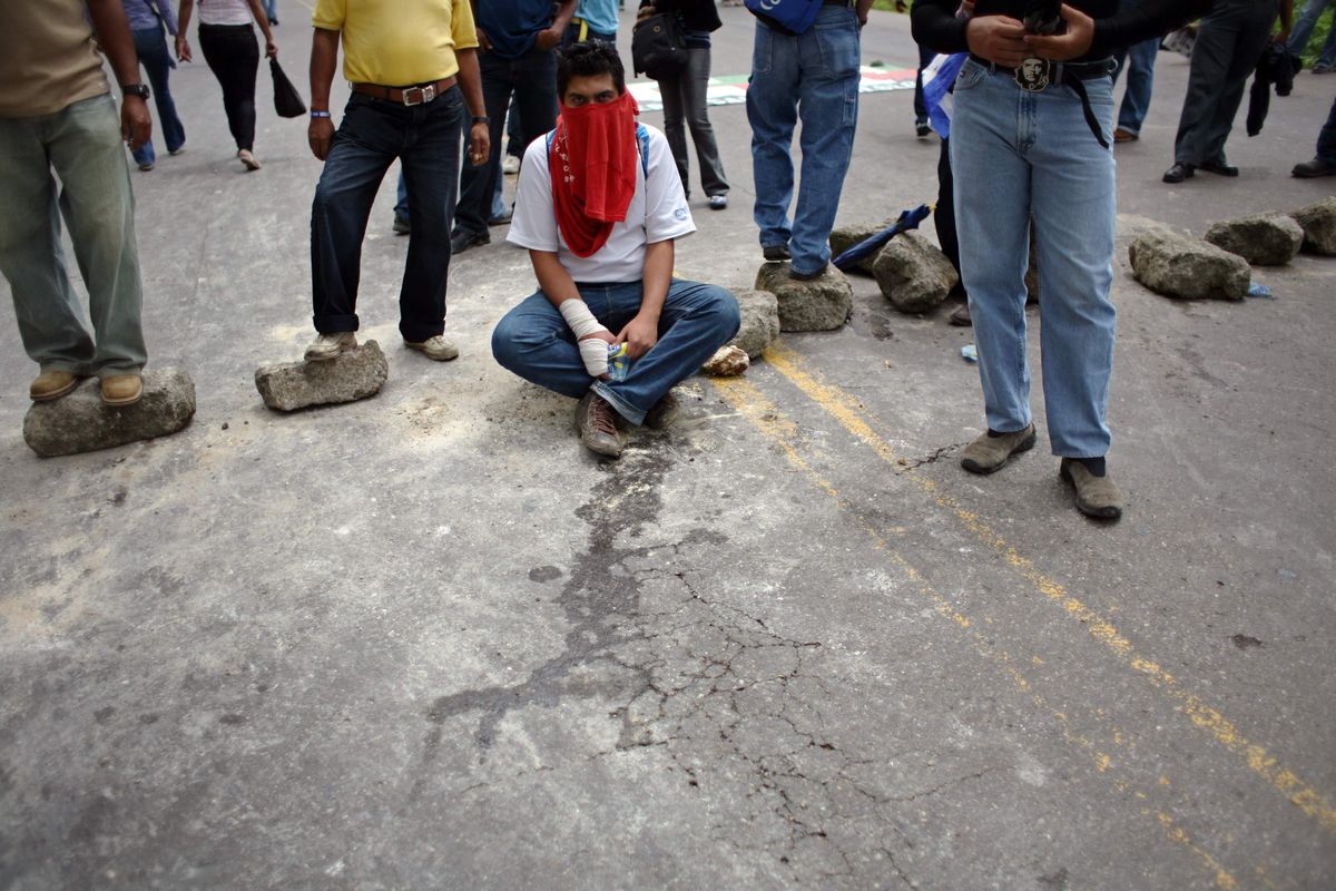 Supporters of  ousted President Manuel Zelaya participate in a roadblock protest in Tegucigalpa, Honduras, on Thursday.  (Associated Press / The Spokesman-Review)