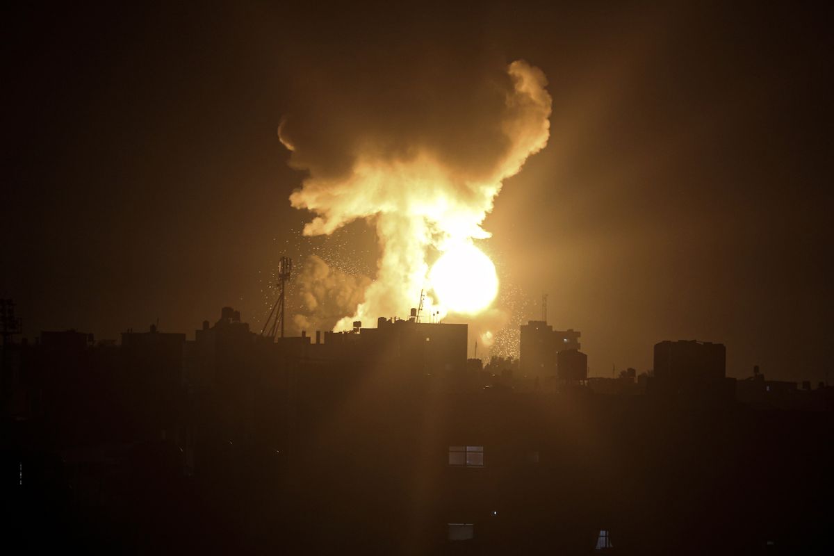 An explosion caused by Israeli airstrikes is seen in the town of Khan Younis, southern Gaza Strip, Sunday Jan, 2, 2022. Israel’s military says it launched strikes against militant targets in the Gaza Strip, a day after rockets were fired from the Hamas-ruled territory.  (Yousef Masoud)