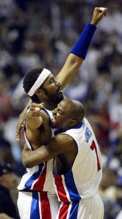 
Detroit's Rasheed Wallace is embraced by Mike James, right, near the end of the Game 5 as the Pistons blew away the Lakers with relative ease to secure their first  NBA title  since 1990. 
 (Associated Press / The Spokesman-Review)