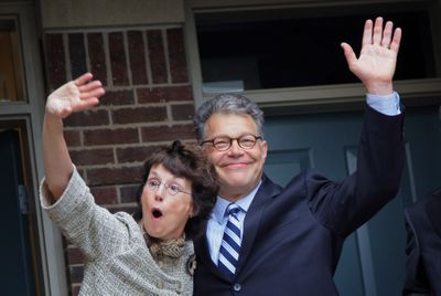 Democrat Al Franken with his wife, Franni, at his side, wave outside their home in Minneapolis on Tuesday.  (Associated Press / The Spokesman-Review)