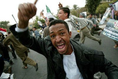 A demonstrator screams slogans Friday in Baghdad, as several hundred thousand people rallied after noon prayers, with many carrying banners denouncing last week's elections.
(Associated Press / The Spokesman-Review)