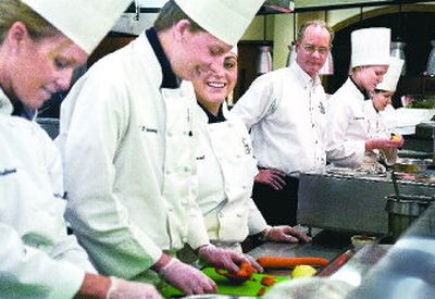 
Inland Northwest Culinary Academy department chair Duane Sunwold, without hat, watches as students, from left, Laurie Faloon, Jeff Schoening and Justina Renoud prepare kidney-healthy food in the kitchen area of Orlando's Restaurant at Spokane Community College. 
 (Photos by Christopher Anderson / The Spokesman-Review)