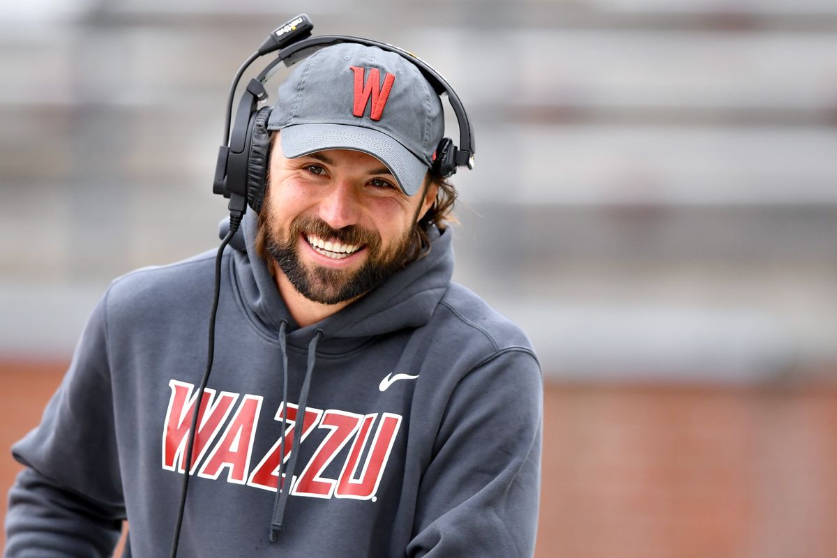 Former WSU standout quarterback Gardner Minshew smiles as he dons a headset to help coach the Crimson team during WSU’s Crimson and Gray spring football game on Saturday, Apr. 27, 2024, at Gesa Field in Pullman, Wash.  (Tyler Tjomsland/The Spokesman-Review)