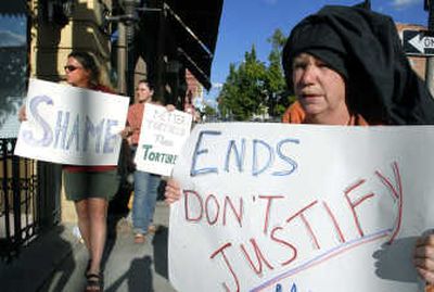 
From left, Kim Stankowich, Willow Moline and Nancy Nelson protest outside the office of Mitchell Jessen & Associates at the corner of Washington Street and Riverside Avenue on Thursday. James Mitchell and Bruce Jessen reportedly helped develop the CIA's interrogation program.  
 (Dan Pelle / The Spokesman-Review)