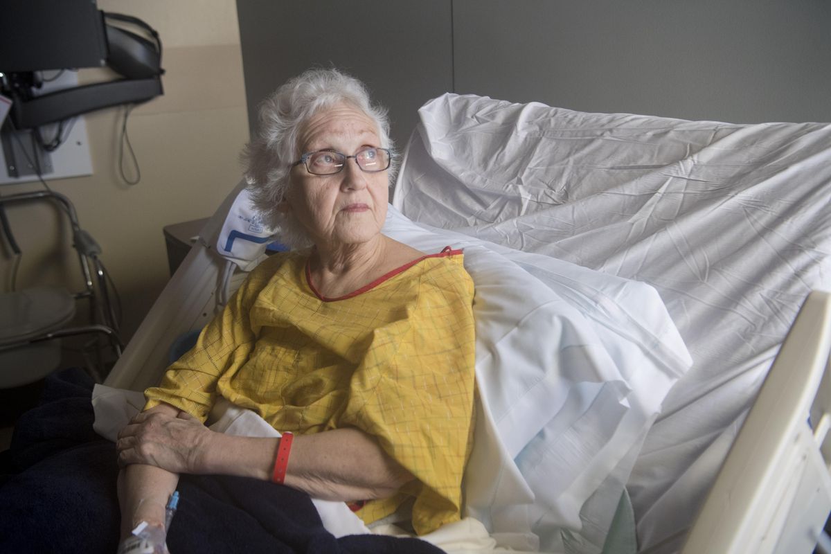 Kathy Kohlieber recovers in a bed at MultiCare Valley Hospital Monday, Feb. 19, 2018, after a purse snatcher in a car dragged her in a Walmart parking lot last Saturday. She broke her pelvis in the assault. (Jesse Tinsley / The Spokesman-Review)