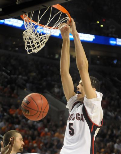 Austin Daye of Gonzaga bends down the rim with a second half dunk  against Akron in the opening round of the NCAA Tournament. (Christopher Anderson / The Spokesman-Review)