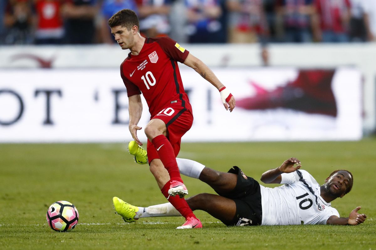 In this June 8, 2017 file photo, U.S. midfielder Christian Pulisic, front, gets past Trinidad & Tobago midfielder Kevin Molino while pursuing the ball during the second half of a World Cup soccer qualifying match in Commerce City, Colo. The United States won 2-0. (David Zalubowski / Associated Press)
