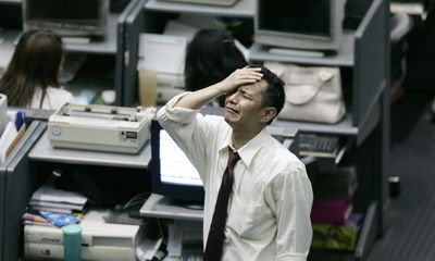 An Indonesian trader reacts  Wednesday, after the nation’s benchmark stock index plunged 10 percent, prompting officials to halt trading.  (Associated Press / The Spokesman-Review)