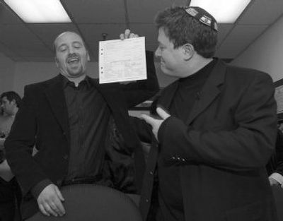
Daniel Gross holds up  a civil union certificate with partner Steven Goldstein  during their ceremony  in Teaneck, N.J.,  early Monday. 
 (Associated Press / The Spokesman-Review)