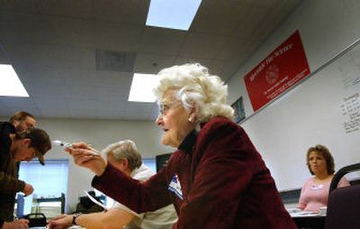 
Verna Steele directs a voter on Tuesday at the Deer Park-Milan precinct in Deer Park. A poll worker for nearly 50 years, she says it's her civic duty to help people vote. 
 (Brian Plonka / The Spokesman-Review)
