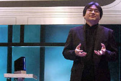 
Nintendo President Satoru Iwata introduces the Nintendo Revolution game console during a press conference in Los Angeles on Tuesday. 
 (Associated Press photos / The Spokesman-Review)