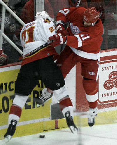 
Calgary's David Hale, left, and Detroit's Dan Cleary collide in the first period. 
 (Associated Press / The Spokesman-Review)