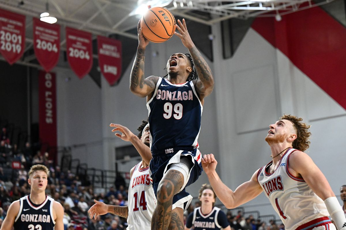 Gonzaga Bulldogs guard Khalif Battle (99) heads to the rim against Loyola Marymount Lions guard Will Johnston (4) during the second half of a college basketball game on Saturday, Jan. 4, 2025, at Gersten Pavilion in Los Angeles, Calif. Gonzaga won the game 96-68.  (Tyler Tjomsland / The Spokesman-Review)