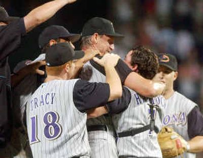 Arizona Diamondbacks pitcher Randy Johnson, right, hugs his