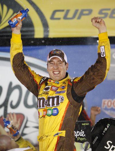 Kyle Busch celebrates after his second win at Bristol this season. (Associated Press / The Spokesman-Review)