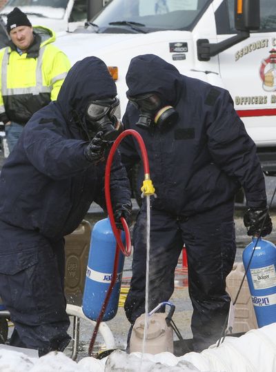 Firefighters work to decontaminate items from a campus ministry at the University of New Hampshire in Durham, N.H., on Tuesday.  (Associated Press)