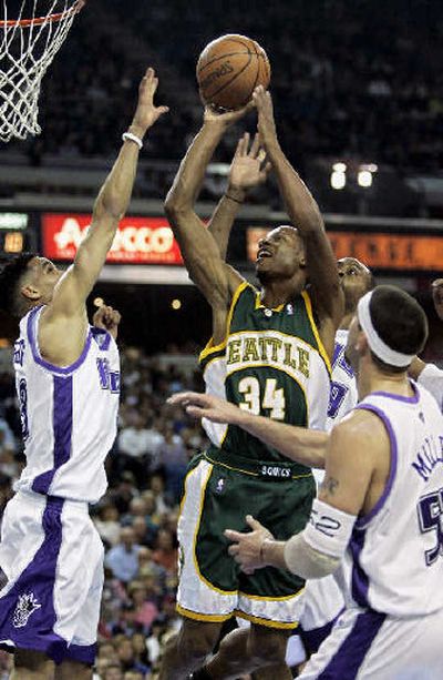 
Sonics guard Ray Allen takes the ball to the basket between three Kings.
 (Associated Press / The Spokesman-Review)