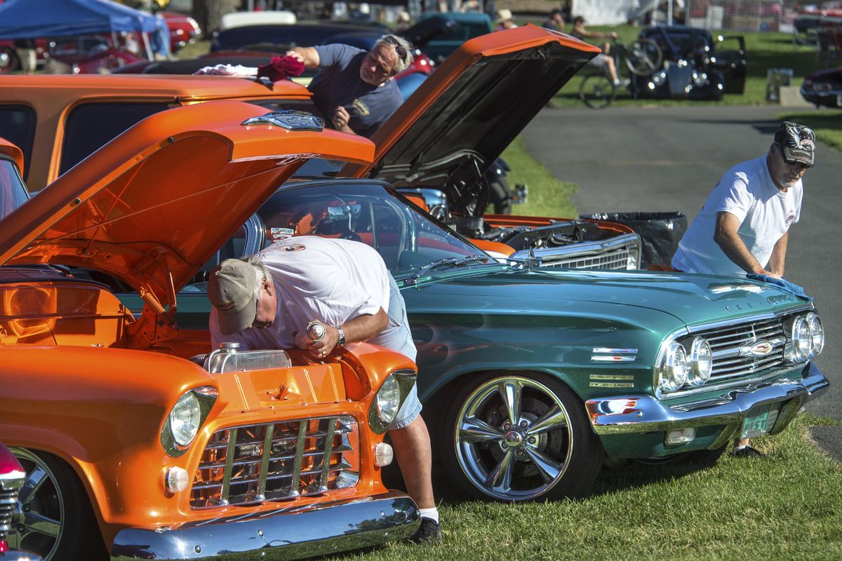Bill Kerekes, left, with his 1955 Chevy, Don Pettit, center, and his 1970 Chevy Blazer and Grant Vessey, with his 1960 Chevy Impala clean up and remove bugs after driving from Calgary, Alberta, for the Goodguys 16th Great Northwest Nationals last year. (Dan Pelle / The Spokesman-Review)