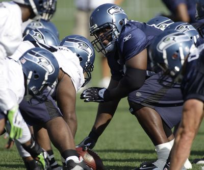 Seahawks center Chris Spencer left practice with an injury Friday. (Associated Press / The Spokesman-Review)