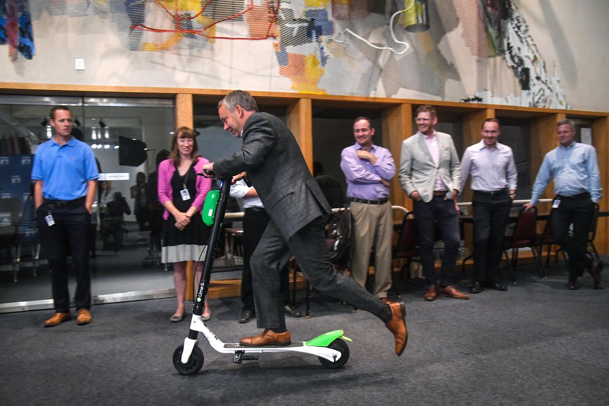 Spokane Mayor David Condon takes a test ride through the Chase in City Hall on a Lime electric scooter, Monday, Aug. 20, 2018. The mayor provided an overview of the upcoming bikeshare pilot program that will begin Sept. 4. (Dan Pelle / The Spokesman-Review)
