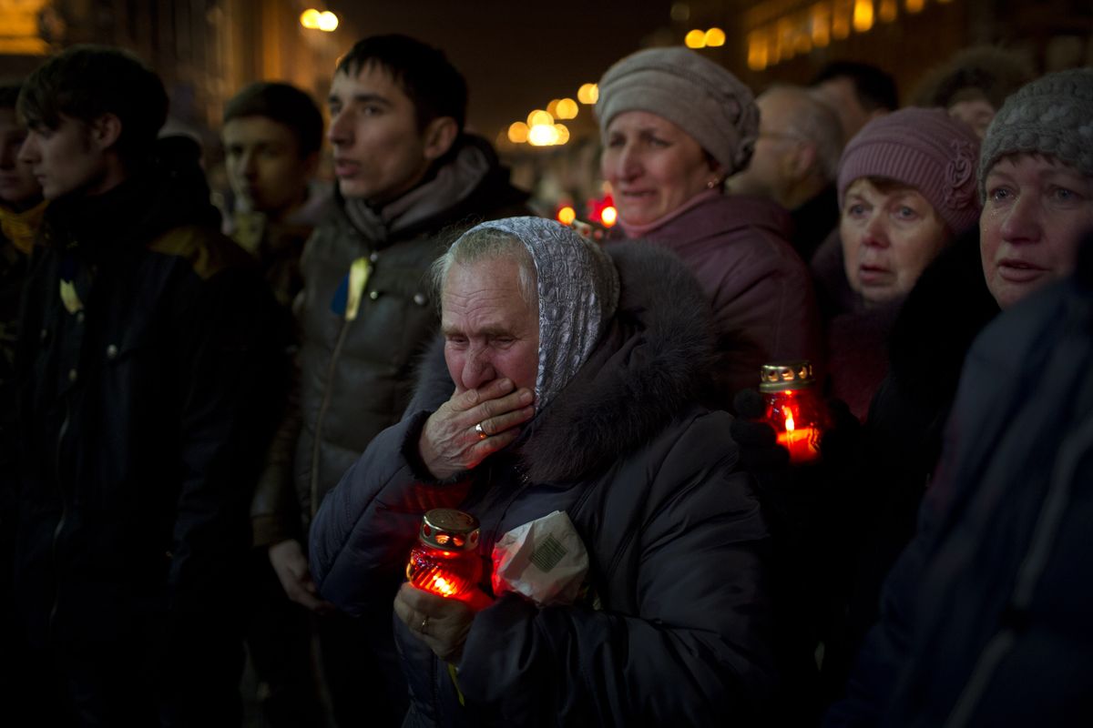Mourners react during the funeral of anti-Yanukovych protester Bailuk Alexander, 40, killed in a recent clash with riot police in Kiev’s Independence Square, Ukraine, on Friday. (Associated Press)