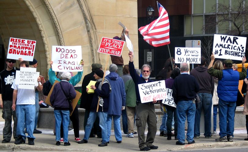 Anti-war activists congregate in front of City Hall after marching through downtown Milwaukee on Friday,  the seventh anniversary of the Iraq war.  (Associated Press)