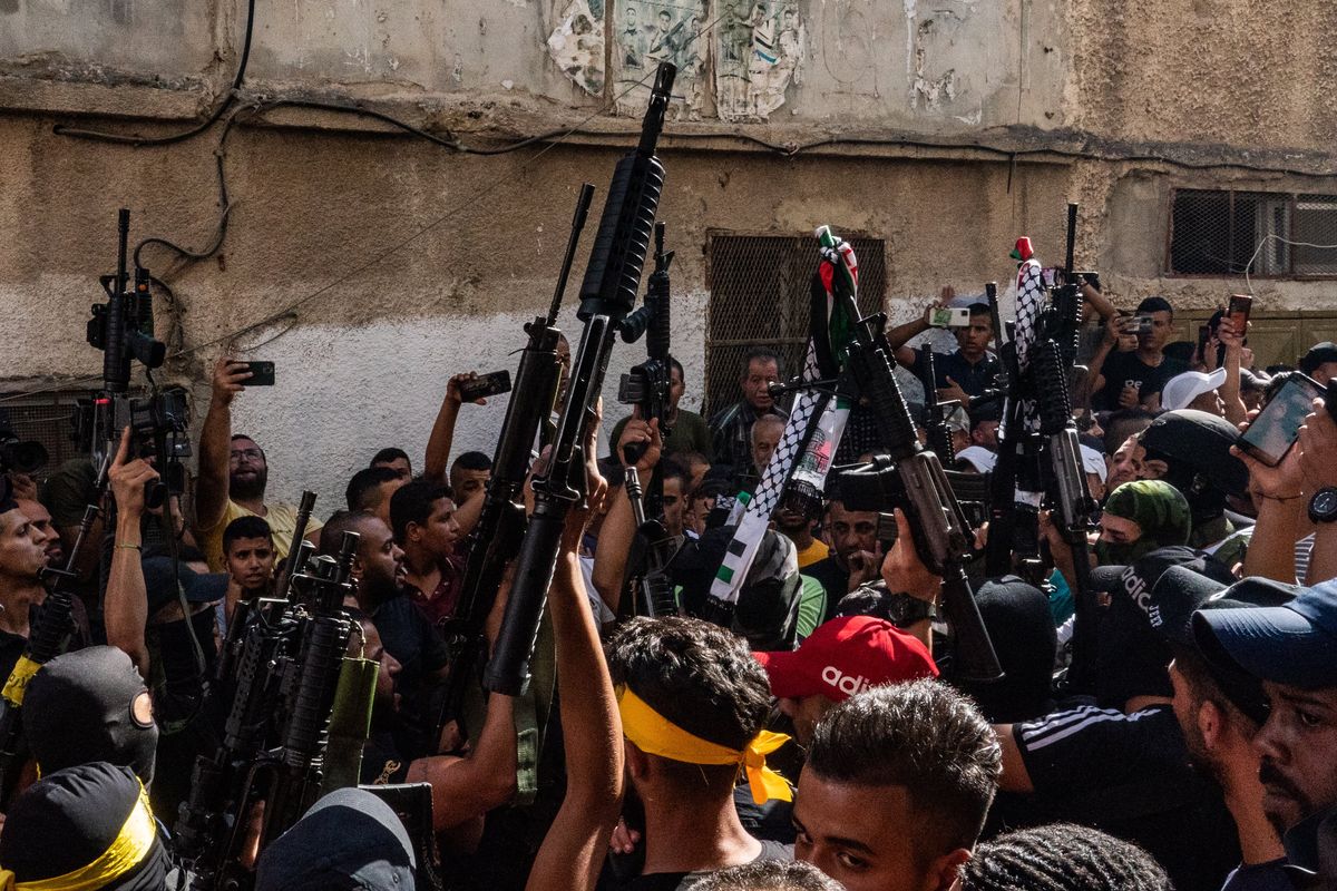 Armed men fire their guns as the body of 15-year-old Imad Khaled Hashash, who was shot while on the roof of his home by Israeli forces, is brought home in Balata refugee camp near Nablus, West Bank. MUST CREDIT: Washington Post photo by Salwan Georges  (Salwan Georges/The Washington Post)