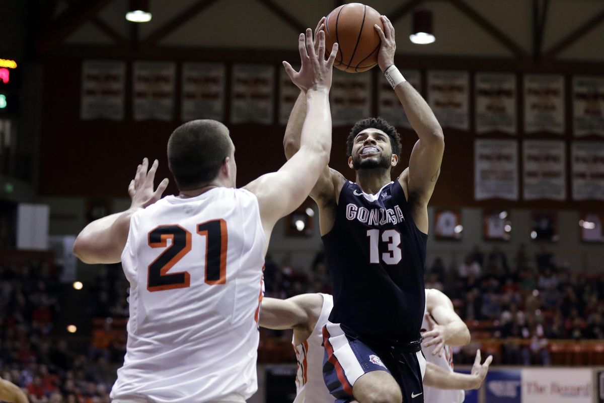 Gonzaga guard Josh Perkins (13) shoots over Pacific forward Jacob Lampkin during the first half of an NCAA college basketball game Saturday, Dec. 31, 2016, in Stockton, Calif. (Marcio Jose Sanchez / Associated Press)