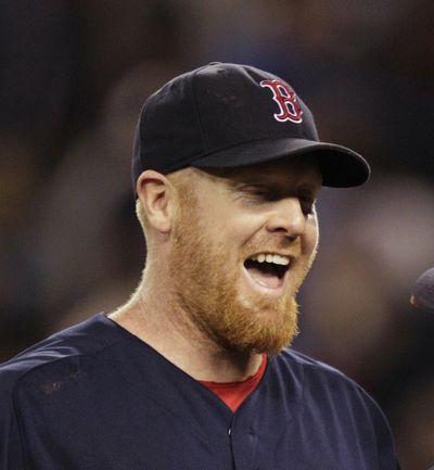 Boston Red Sox starting pitcher Aaron Cook, left, greets David Ortiz after Cook threw a two-hit shutout against the Seattle Mariners in a baseball game, Friday, June 29, 2012, in Seattle. The Red Sox beat the Mariners 5-0. (Ted Warren / Associated Press)