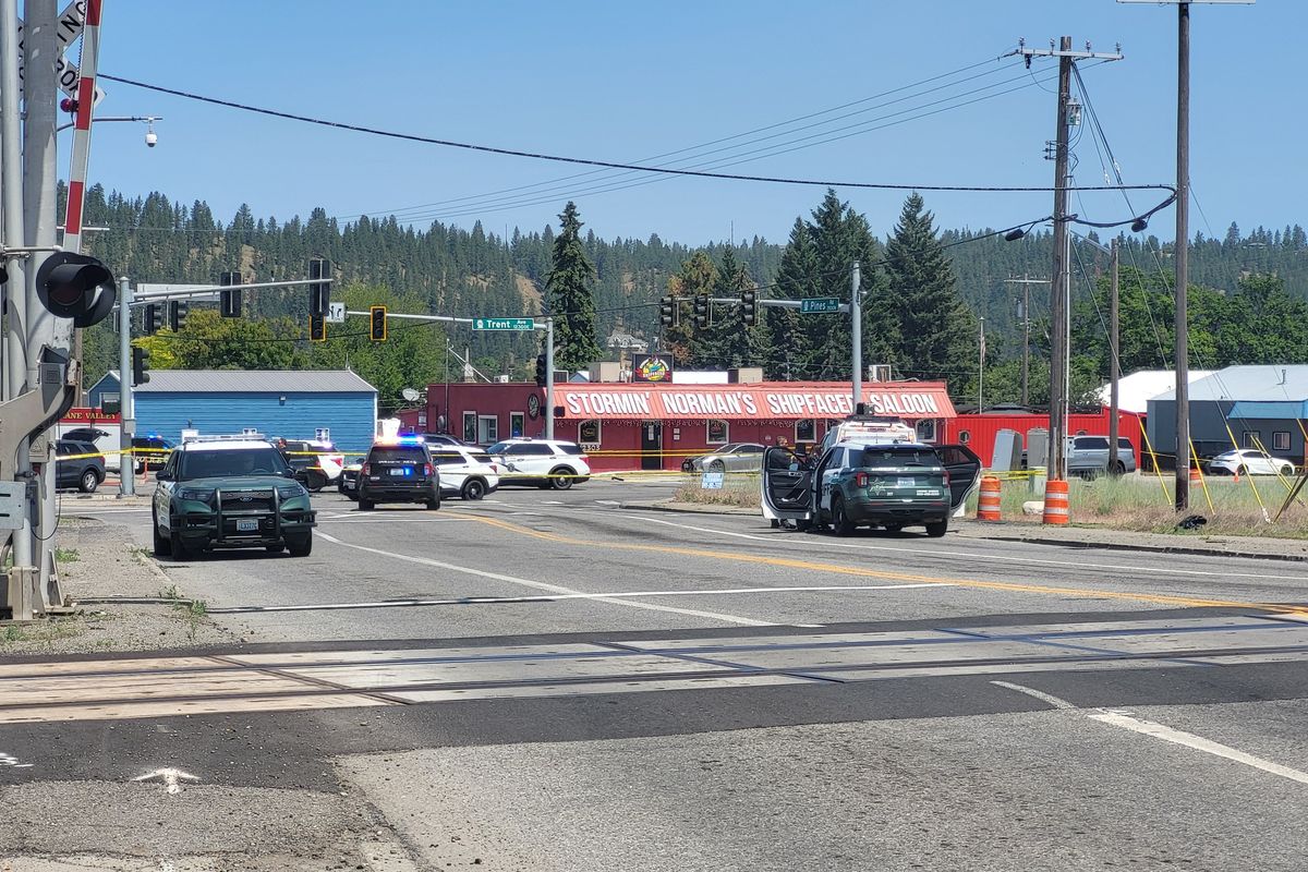 Law enforcement investigate the scene at the intersection of Trent Avenue and Pines Road around 11 a.m. Sunday in Spokane Valley. (Corbin Vanderby/The Spokesman-Review)