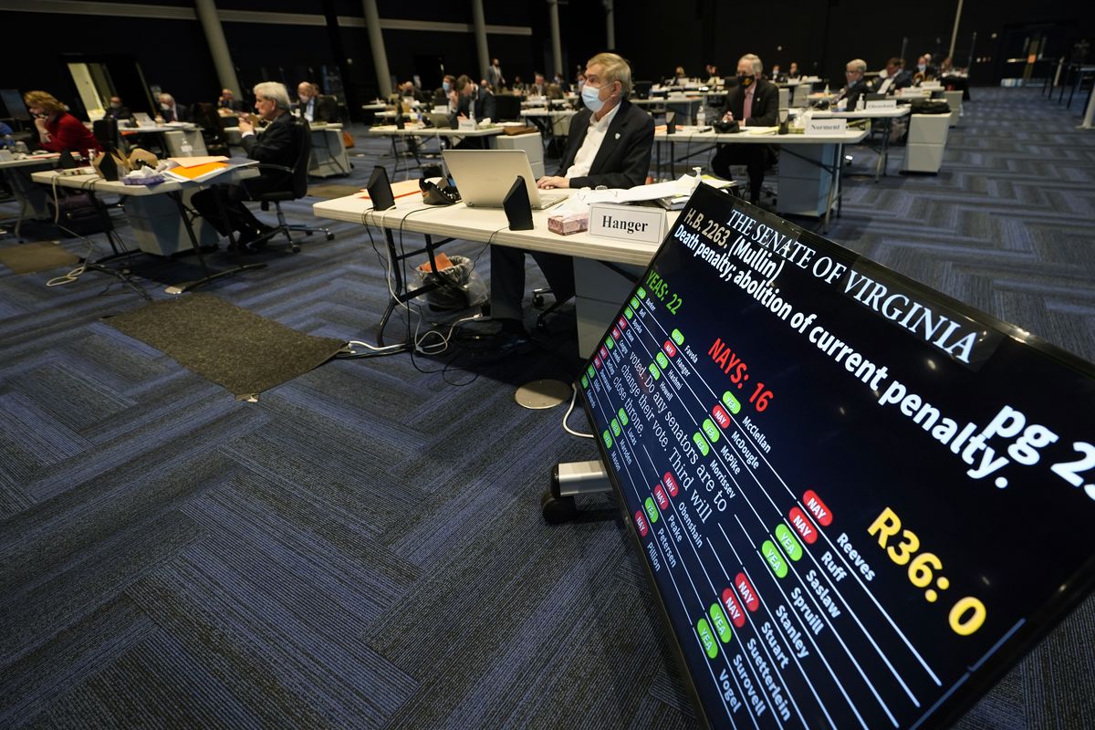 Virginia State Sen. Emmett Hanger, R-Augusta, front, looks at the vote tally board during a vote on a death penalty abolition bill at the Senate session at the Science Museum of Virginia in Richmond, Va., Monday, Feb. 22, 2021. The Senate passed the bill 22-16. (Steve Helber)
