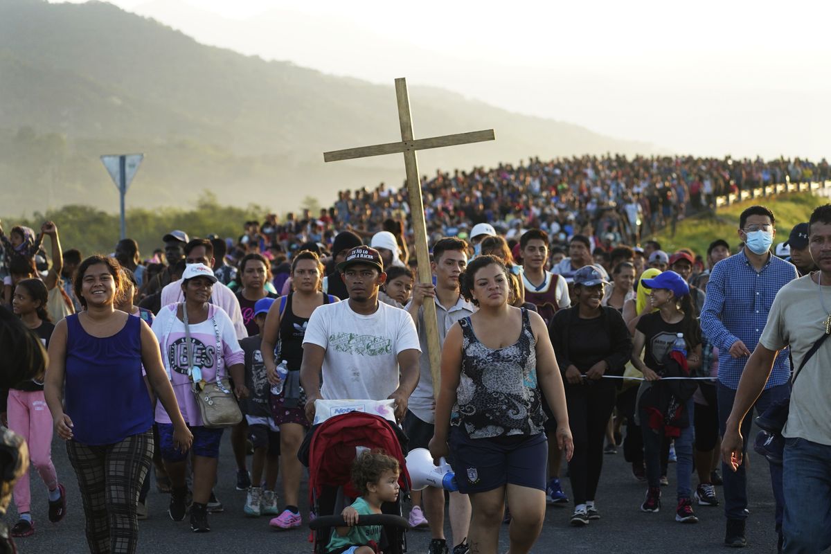 Migrants leave Huixtla, Chiapas state, Mexico, early Wednesday, Oct. 27, 2021, as they continue their trek north toward Mexico