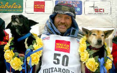 
Iditarod Trail Sled Dog winner Robert Sorlie of Norway sits with his lead dogs Socks, left, and Blue. 
 (Associated Press / The Spokesman-Review)