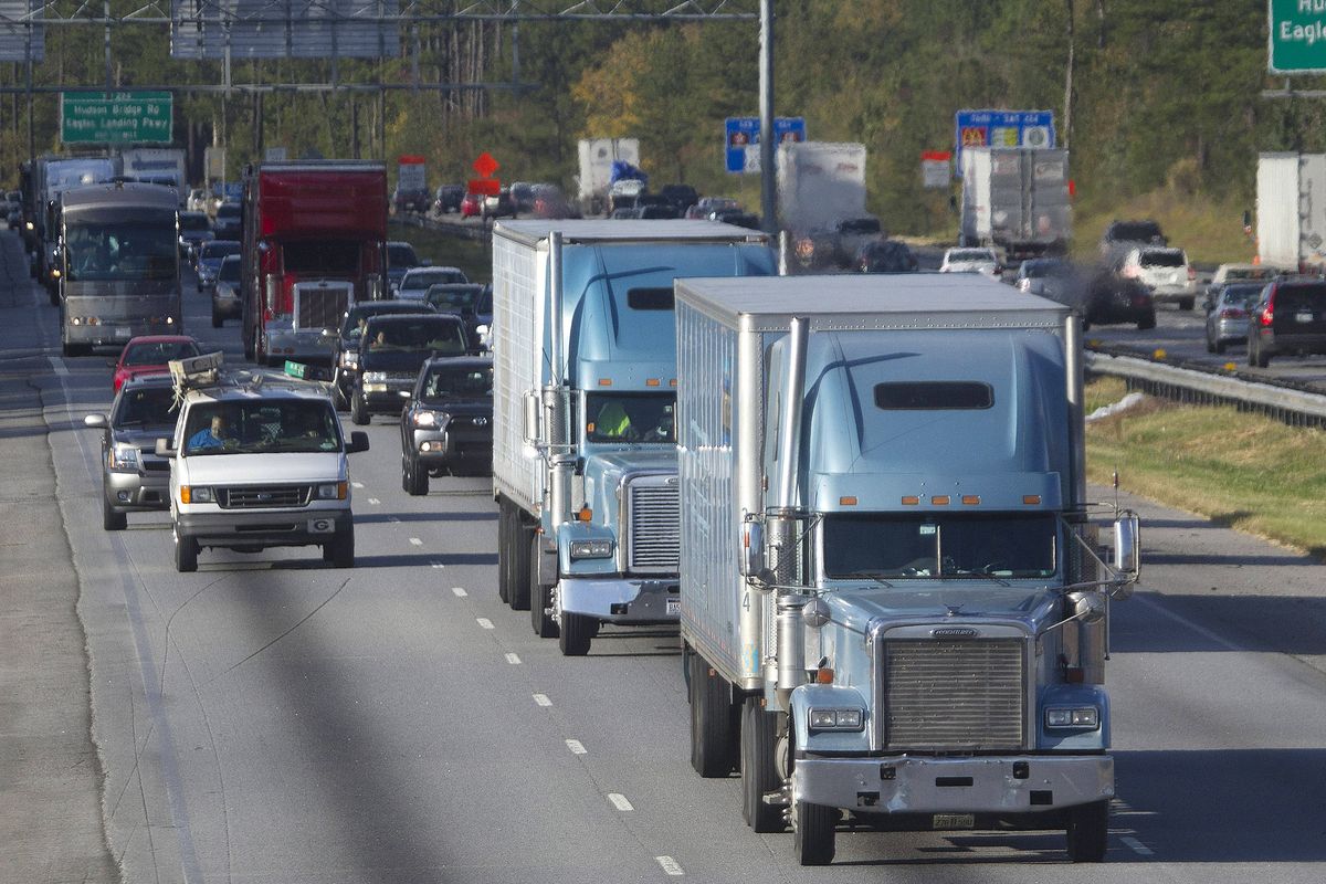 In this photo taken Monday, trucks travel along Interstate 75 near Stockbridge, Ga. Even amid a struggling economy with high unemployment, trucking companies have a tough time hiring young drivers willing to hit the road for long hauls. (Associated Press)