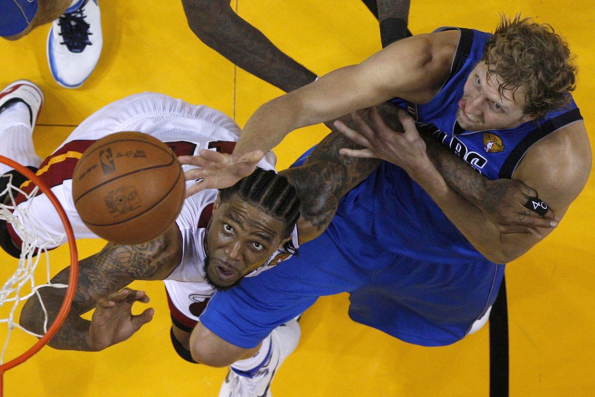 Dirk Nowitzki, right, of the Mavericks, battles for a rebound with Udonis Haslem in the second half in Game 1 of the NBA finals in Miami. (Associated Press)