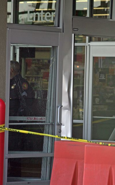 Nassau County police stand just beyond the broken door of the Wal-Mart in Valley Stream, N.Y.   (Associated Press / The Spokesman-Review)