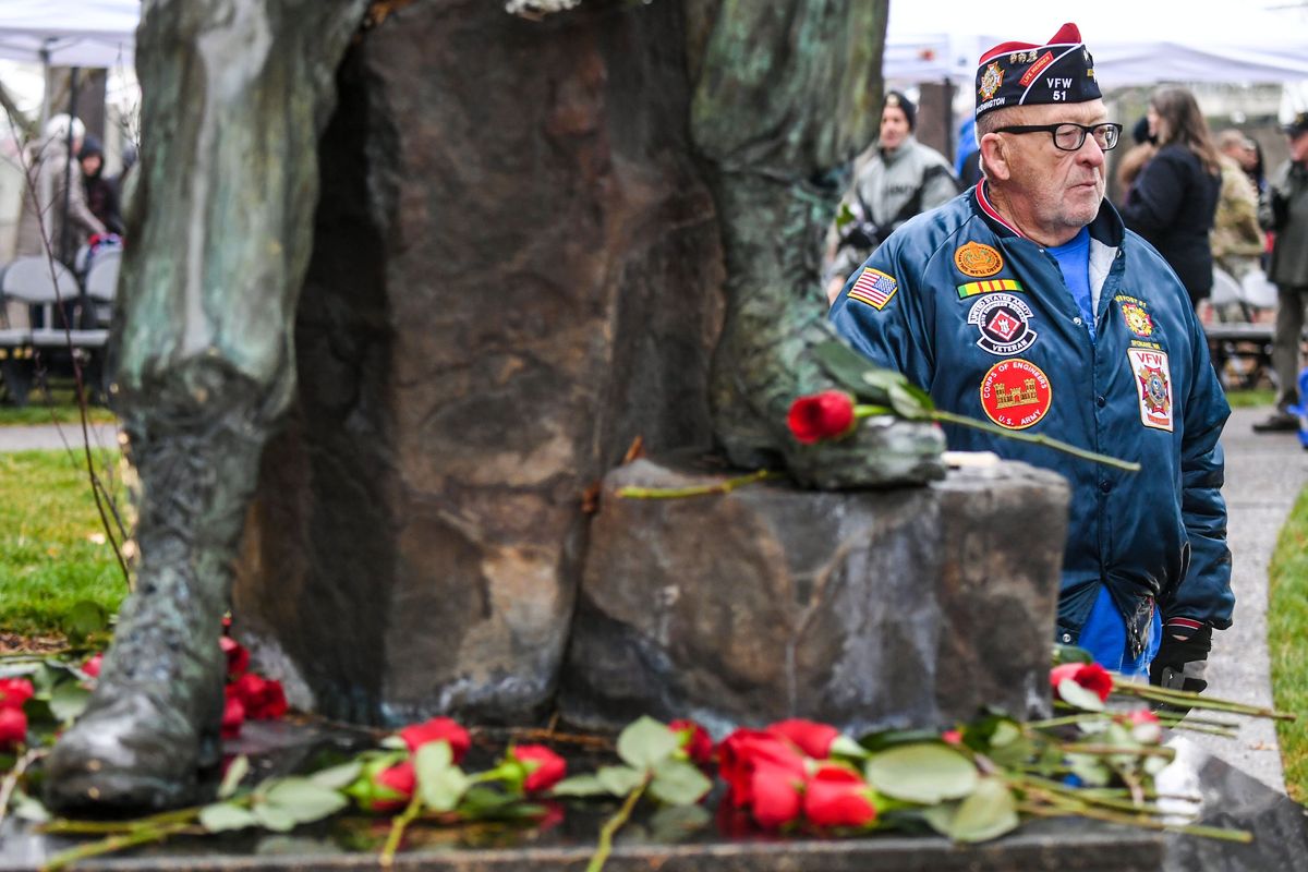 U.S Army veteran Cody Hurst visited the names of a pair of Rogers High School classmates, Larry Jameson and Roy Johnson, on the Vietnam Veterans Memorial after a rededication ceremony, Thursday, Nov. 11, 2021 in Riverfront Park.  (DAN PELLE/THE SPOKESMAN-REVIEW)