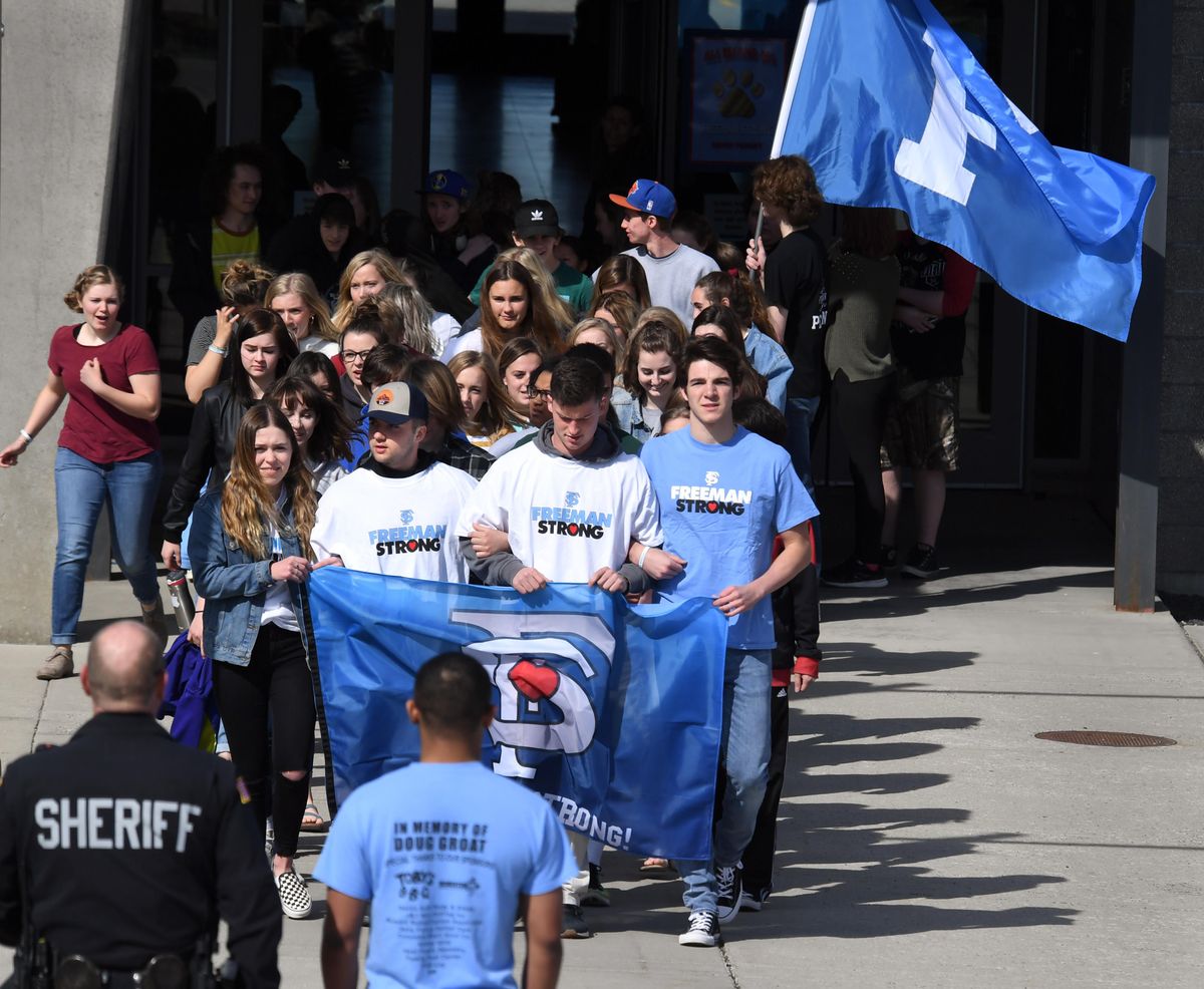 Freeman High School students march from the main entrance as they participate in a nation-wide walkout to protest gun violence, Friday, April 20, 2018. (Dan Pelle / The Spokesman-Review)