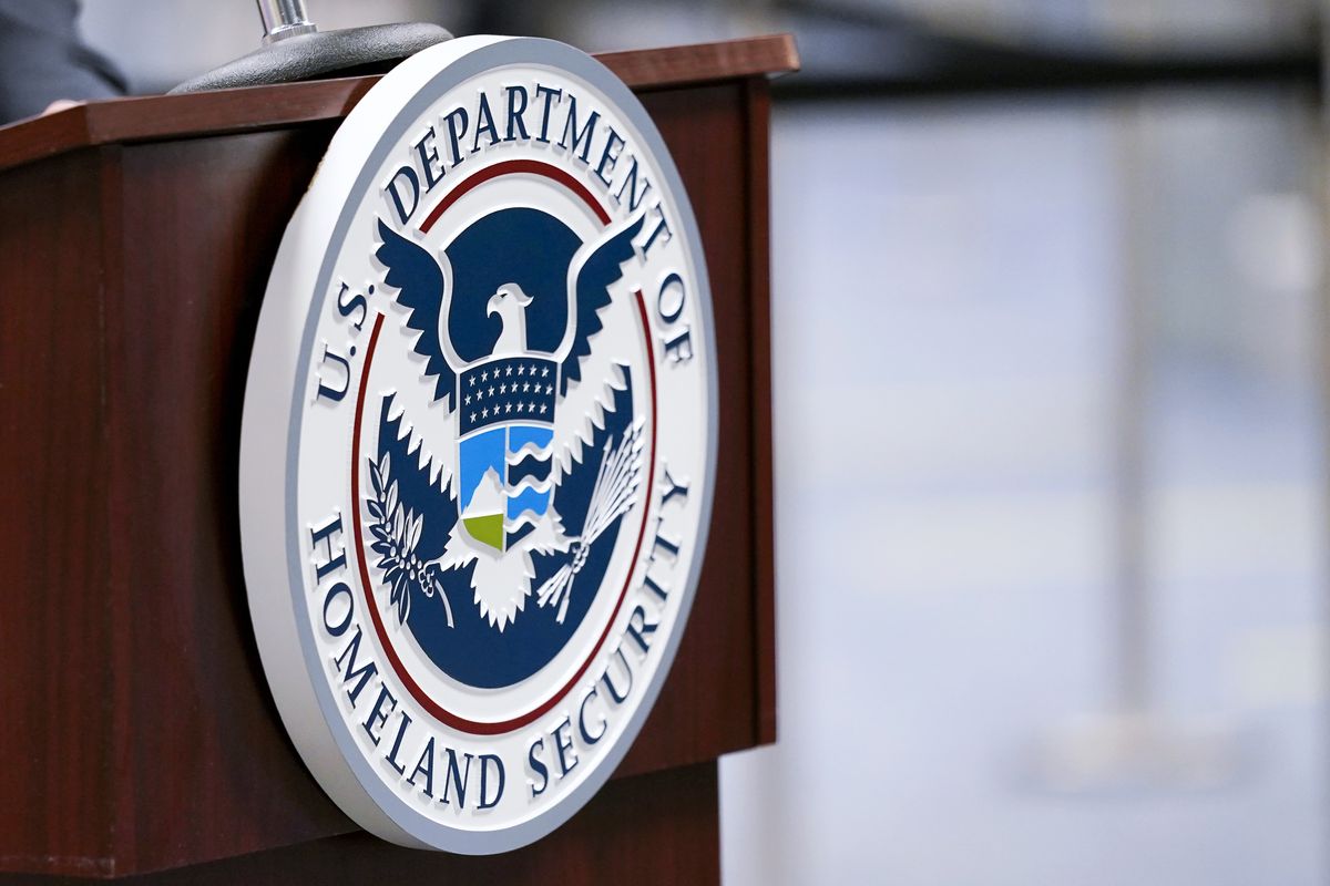 A U.S. Department of Homeland Security plaque is displayed a podium as international passengers arrive at Miami international Airport on Nov. 20, 2020, where they are screened by U.S. Customs and Border Protection in Miami.  (Lynne Sladky)