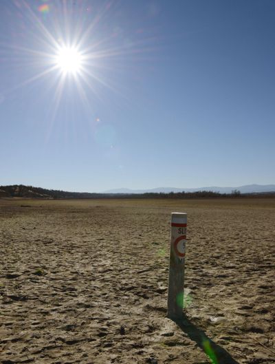 A 5 mph boating speed limit buoy is stuck in the ground at Black Butte Lake in Orland, Calif., in January. (Associated Press)