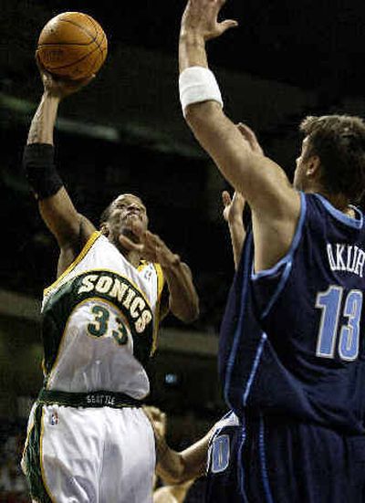 
Seattle's Antonio Daniels shoots over Utah's Mehmet Okur on Sunday.
 (Associated Press / The Spokesman-Review)