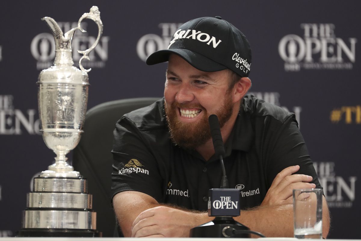 Ireland’s Shane Lowry smiles as he sits next to the Claret Jug trophy while attending a news conference after winning the Open Championship at Royal Portrush on July 21, 2019. (Peter Morrison)