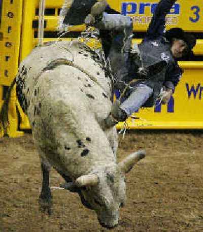 
Zeb Lanham, of Sweet, Idaho, rides Smokeless War Dance during the second go-round of bull riding, which Lanham won. 
 (Associated Press / The Spokesman-Review)