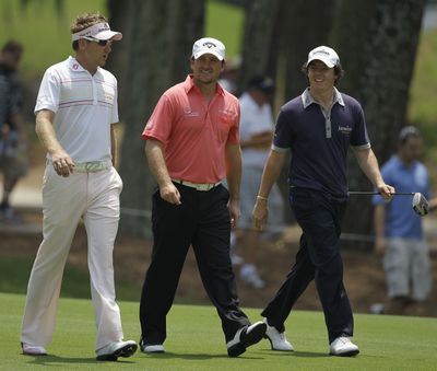 England’s Ian Poulter, left, and Northern Ireland players Graeme McDowell, center, and Rory McIlroy, at practice last month in Florida, are part of a large foreign contingent of players on the PGA Tour.  (Associated Press)