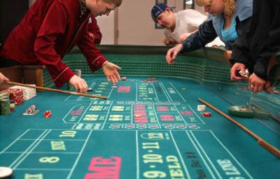 
Brandon Grosshuesch left, practices dealing at the craps table to his classmates Ryan Browning and Annetta Klein during their class. 
 (Kathryn Stevens / The Spokesman-Review)