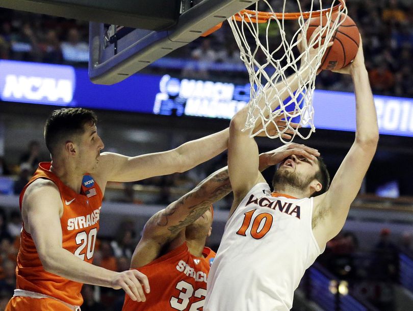 Virginia's Mike Tobey (10) shoots against Syracuse's Tyler Lydon (20) and DaJuan Coleman (32) during the second half of Sunday’s game in Chicago. (Nam Y. Huh / Associated Press)